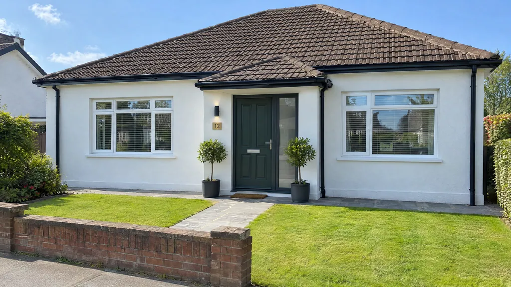 Front porch bungalow extension idea on a 1970s bungalow in Dublin, a small pitched-roof porch with a glazed side panel.