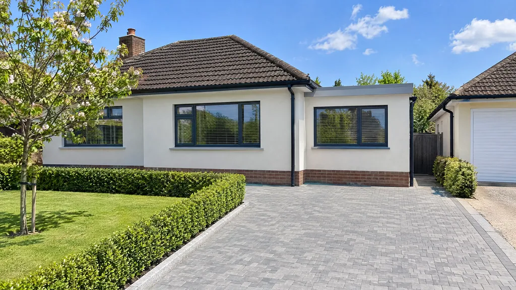 Bungalow extension idea where an attached garage on a 1970s Dublin bungalow is converted into a bright bedroom with a new front window.