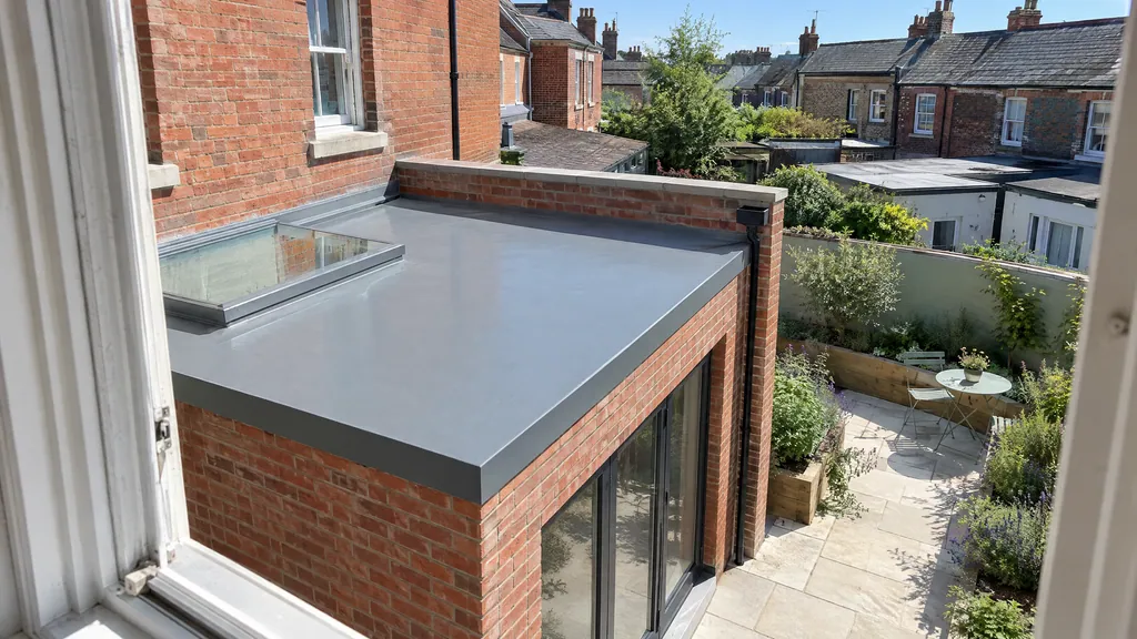 Grey GRP fibreglass flat roof extension on a Victorian terrace in Dublin, falling to a single parapet outlet.