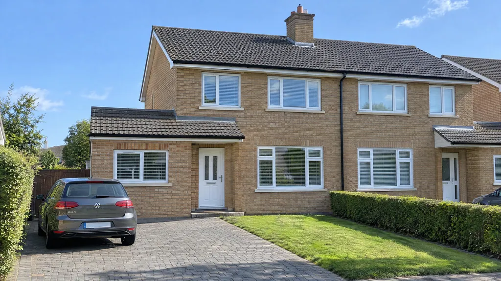 A 1990s buff-brick semi in Lucan with a neat garage conversion front, where a new window matching the neighbouring houses kept it exempt from planning permission.