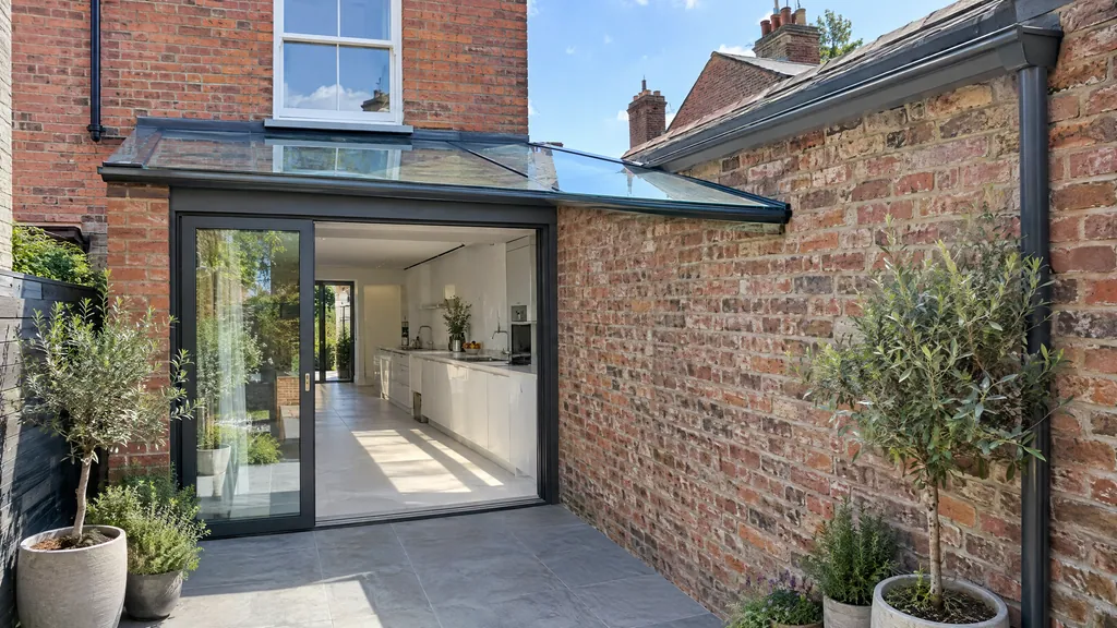 Side return kitchen extension idea on a Victorian redbrick terrace in Phibsborough, with a sloped glass roof along the boundary wall.