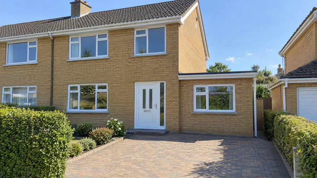 A garage door filled in with matching brick and a new window, part of turning a garage into an office on a Dublin semi.