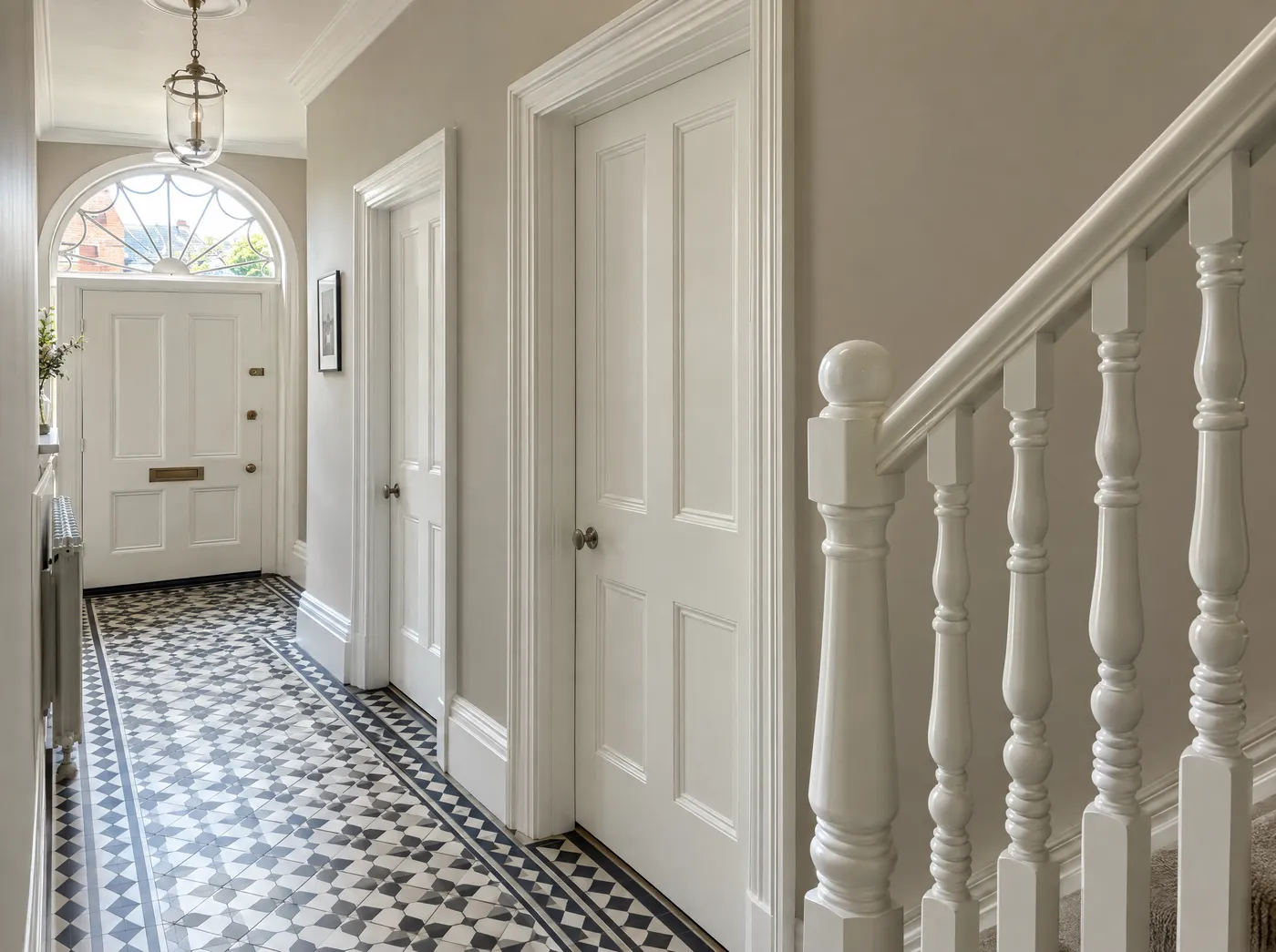 Freshly painted panelled doors, skirting and banisters in a Dublin hall