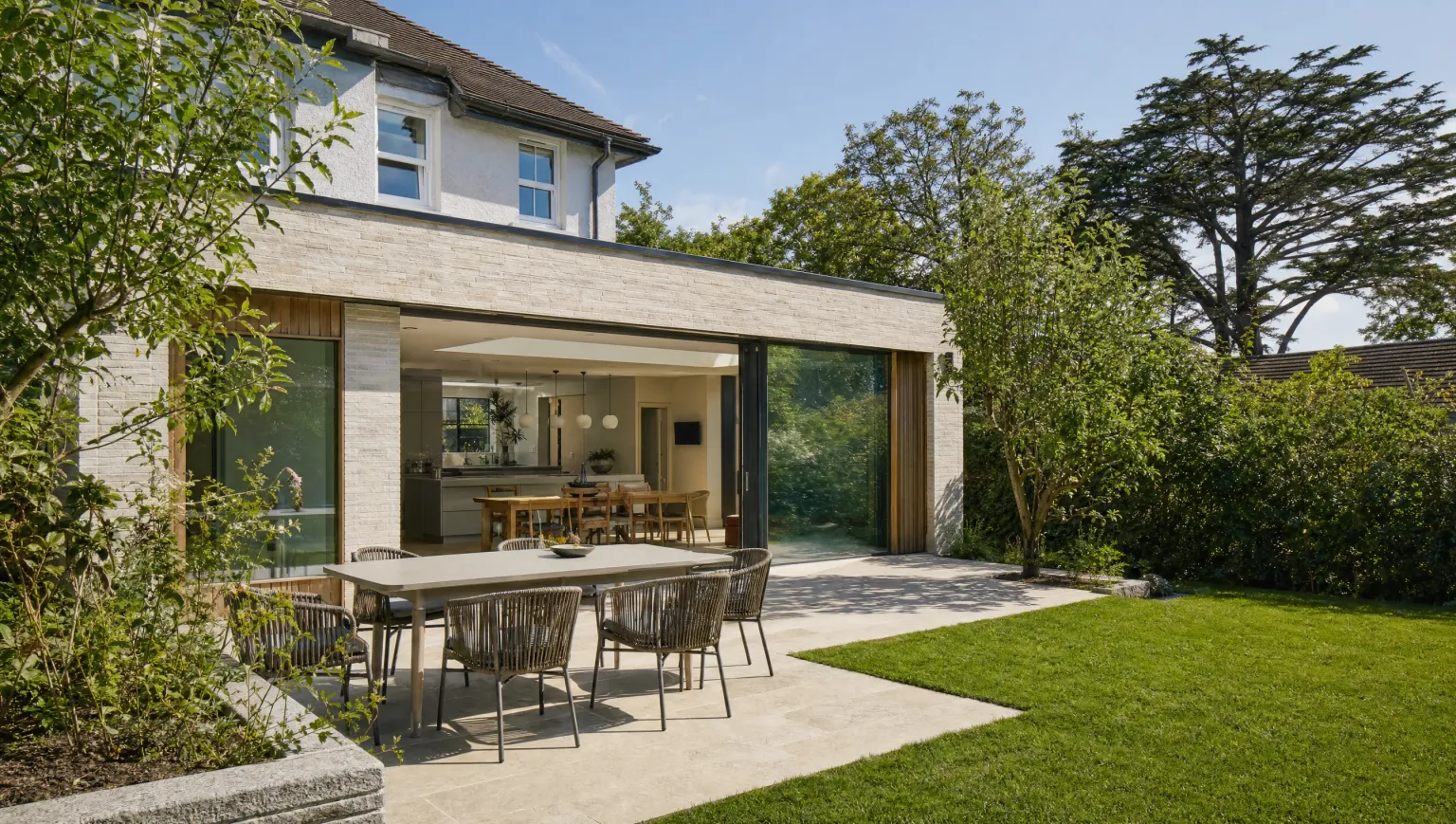 Contemporary kitchen extension opening onto a patio