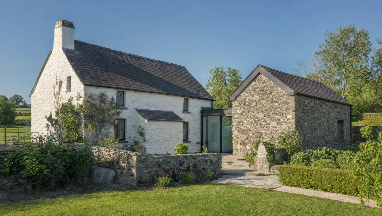 Glazed link joining a cottage to a stone outbuilding